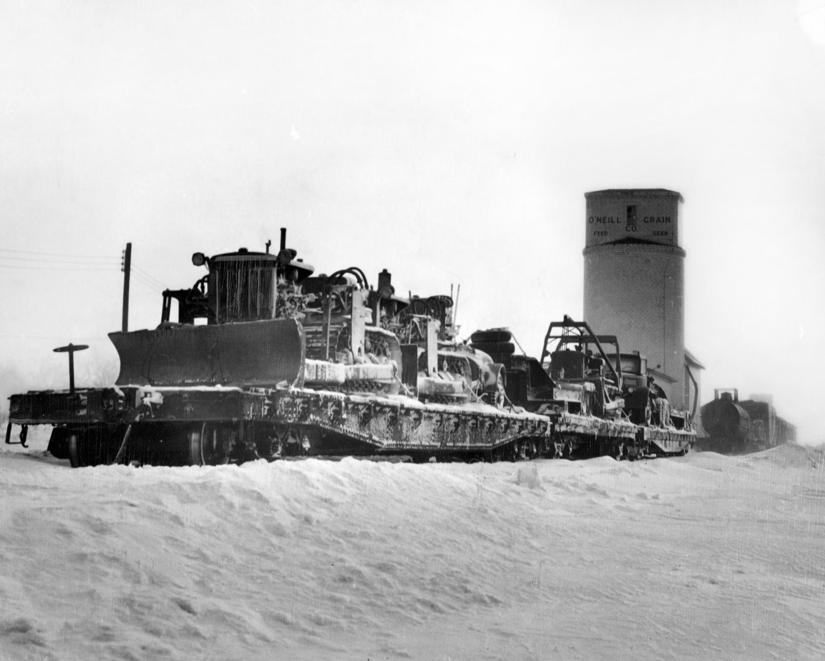 Three Army Engineer bulldozers arrive at O'Neill. Published Jan. 30, 1949.